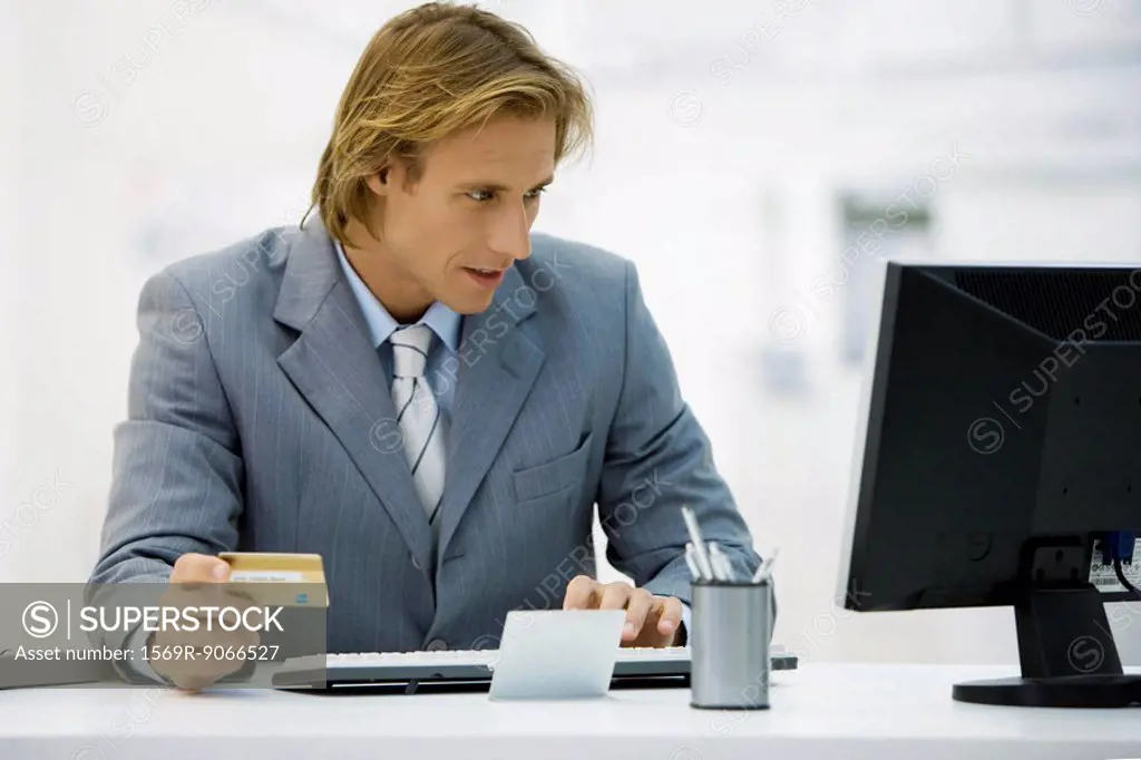 Businessman making online purchase with credit card