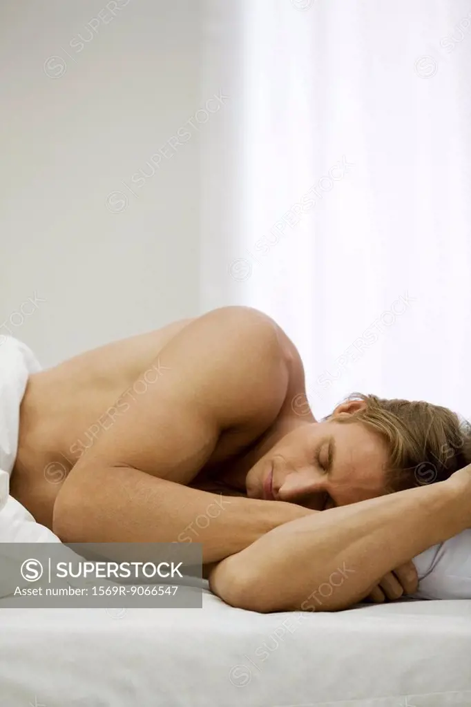 Man lying on side in bed sleeping