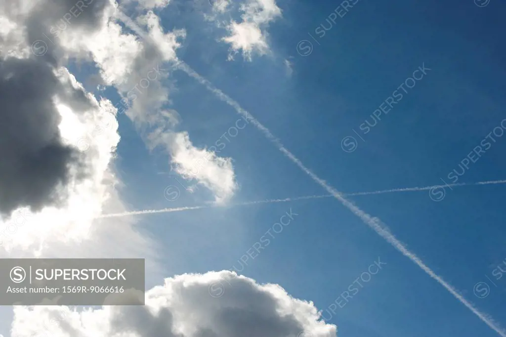 Blue sky with clouds and vapor trails