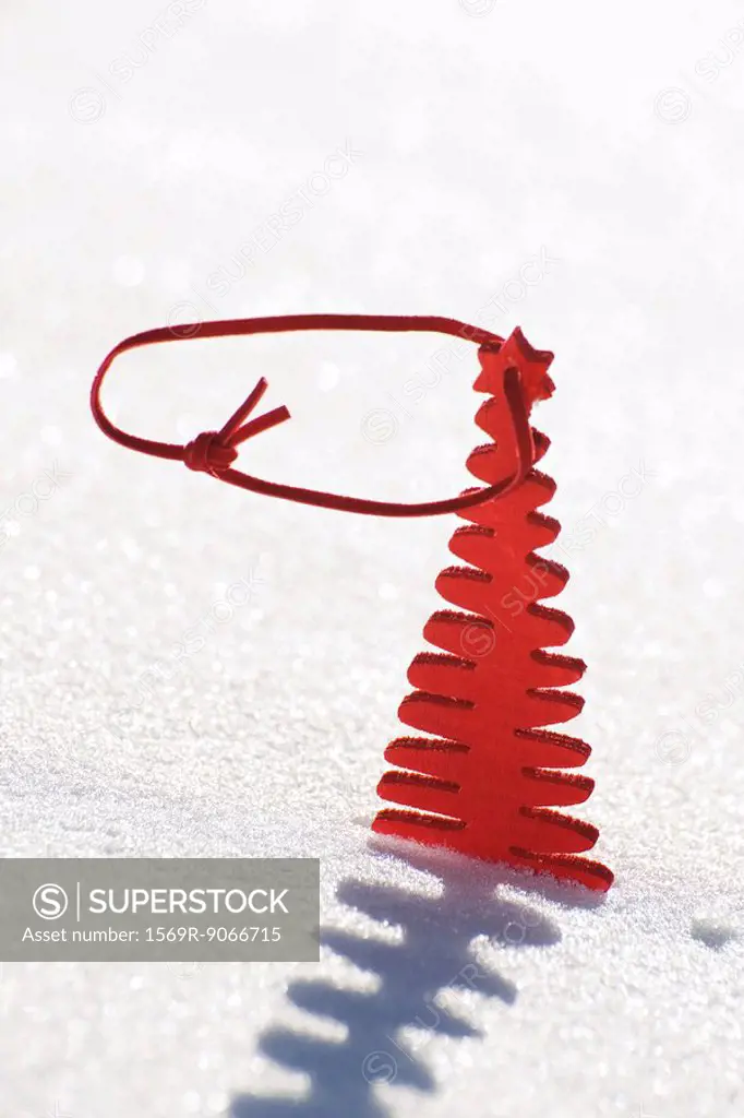 Red wooden Christmas tree decoration set in snow