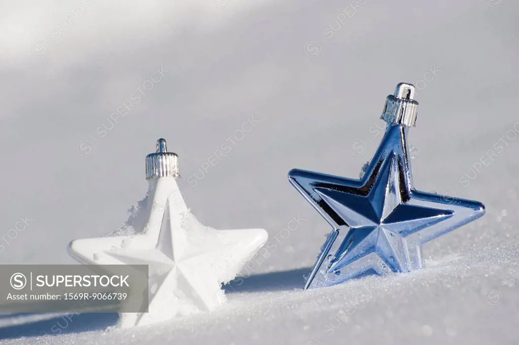 Star Christmas ornaments in snow