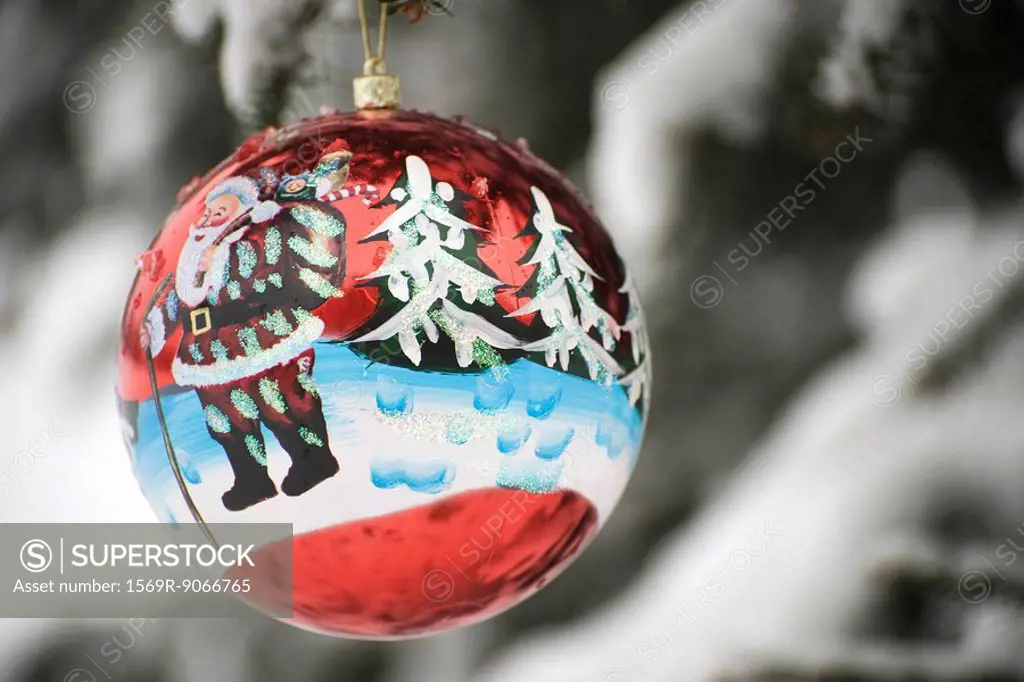 Colorful Christmas ornament hanging from branch