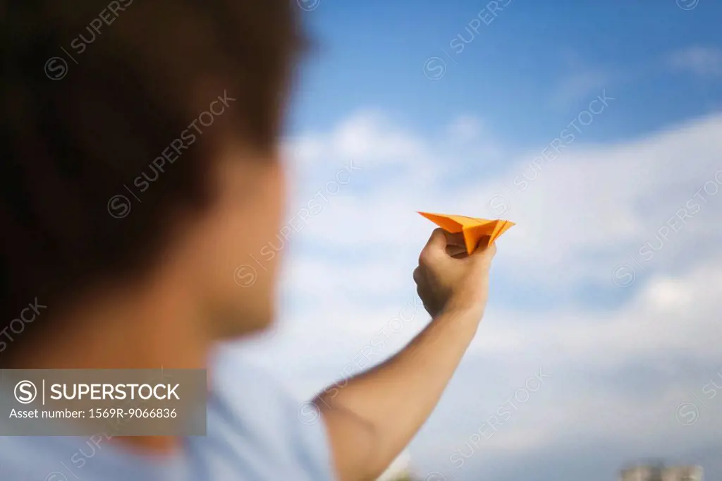 Man throwing paper airplane