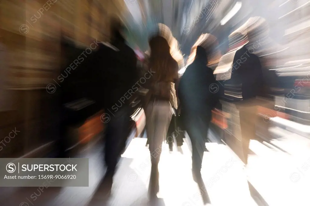 Pedestrians walking, rear view, blurred