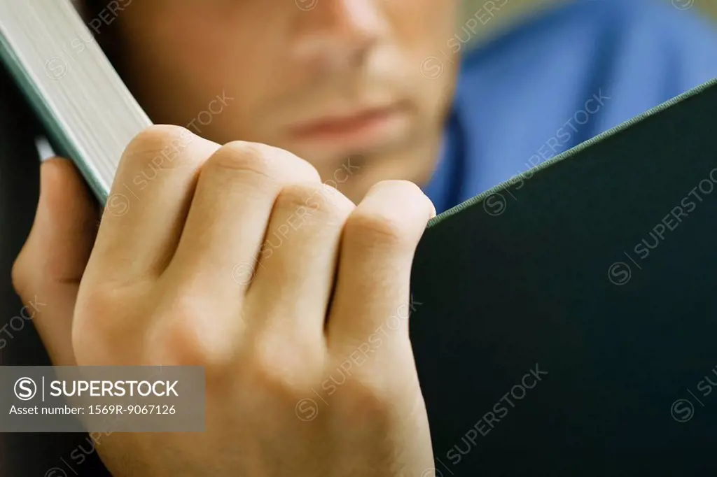 Man reading book, cropped