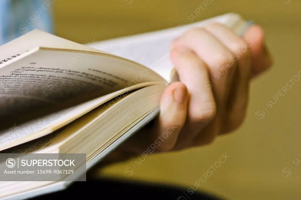Person reading book, cropped