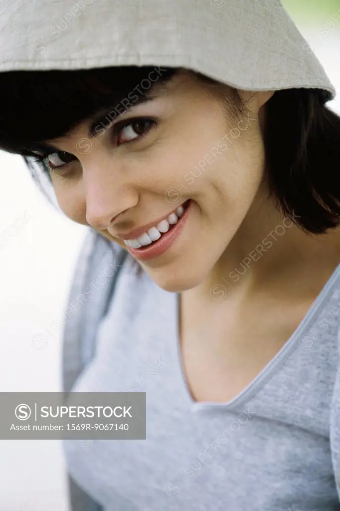 Woman smiling flirtatiously at camera, portrait