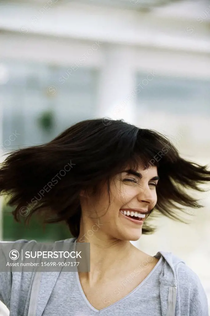 Woman tossing hair, portrait