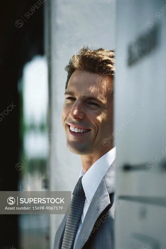 Businessman smiling and looking away, portrait