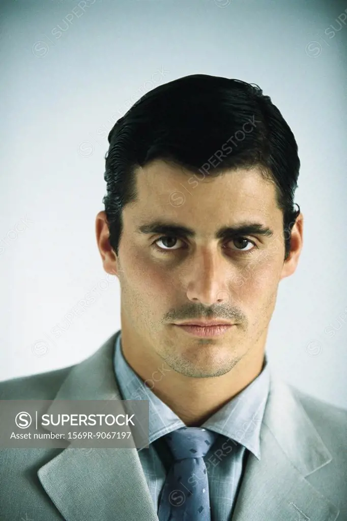 Businessman looking confidently at camera, portrait