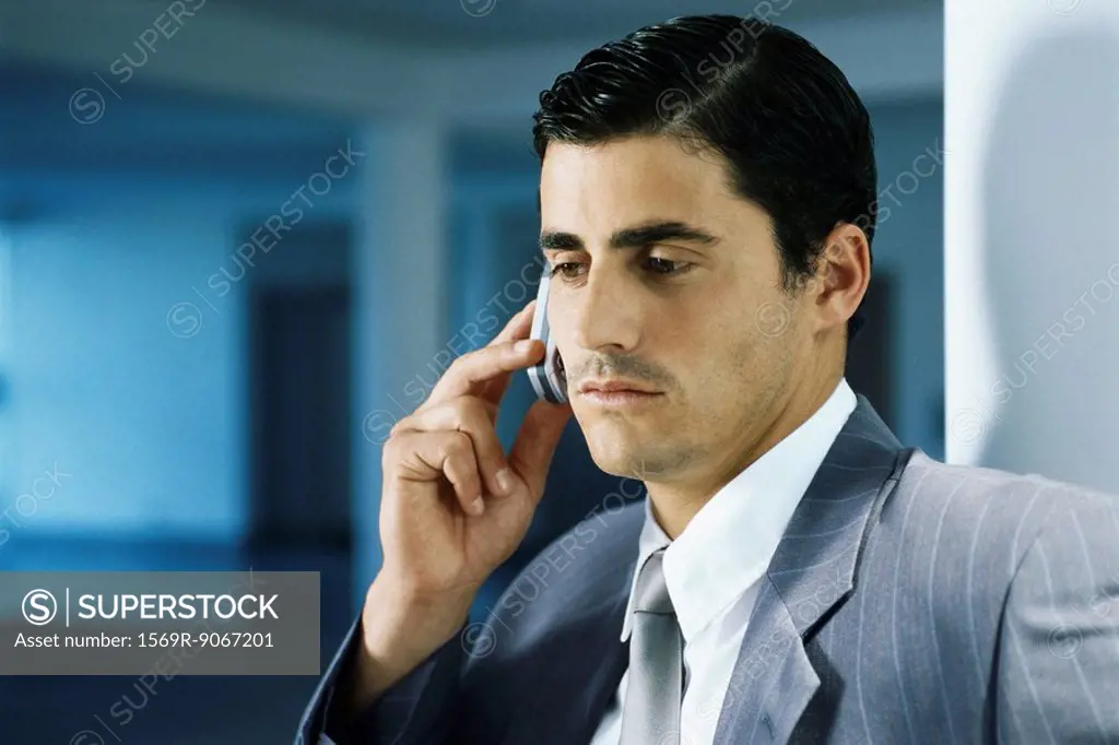 Businessman using cell phone, portrait