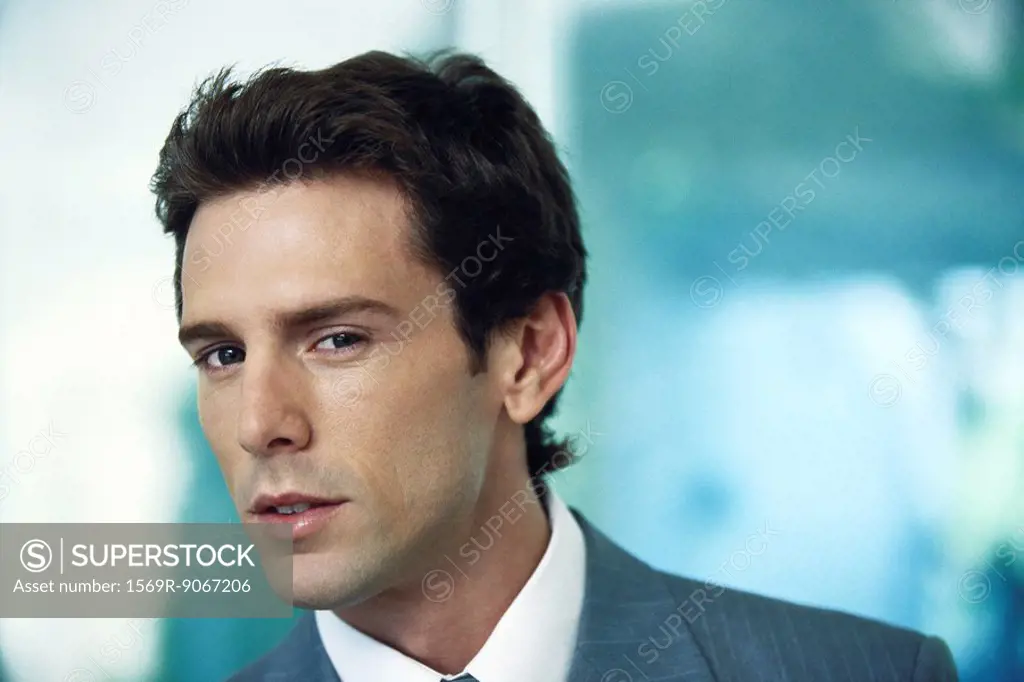 Businessman looking at camera with interest, portrait