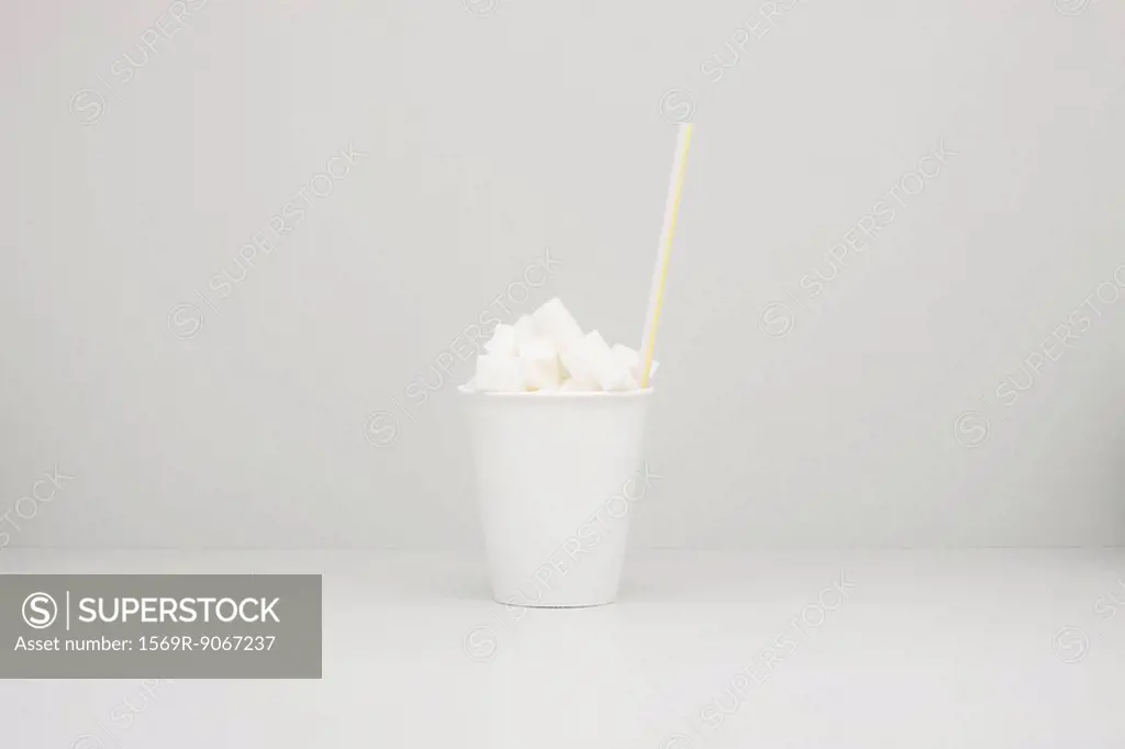 Food concept, disposable cup filled with sugar cubes