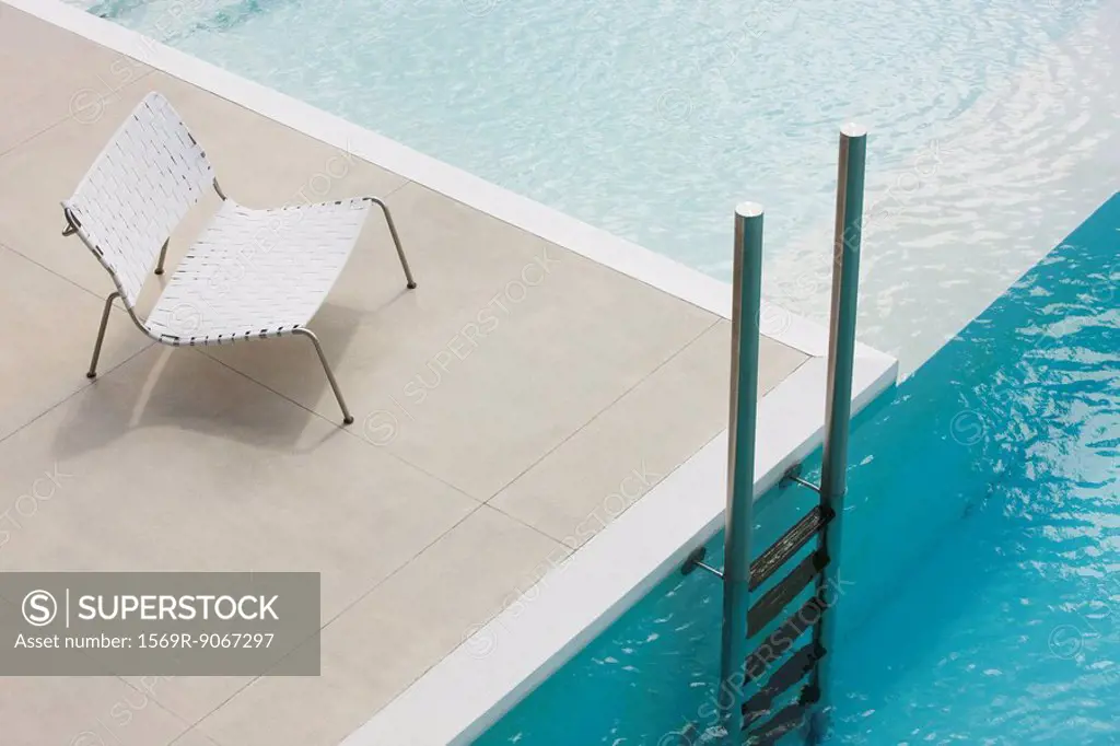 Chair at edge of pool near ladder