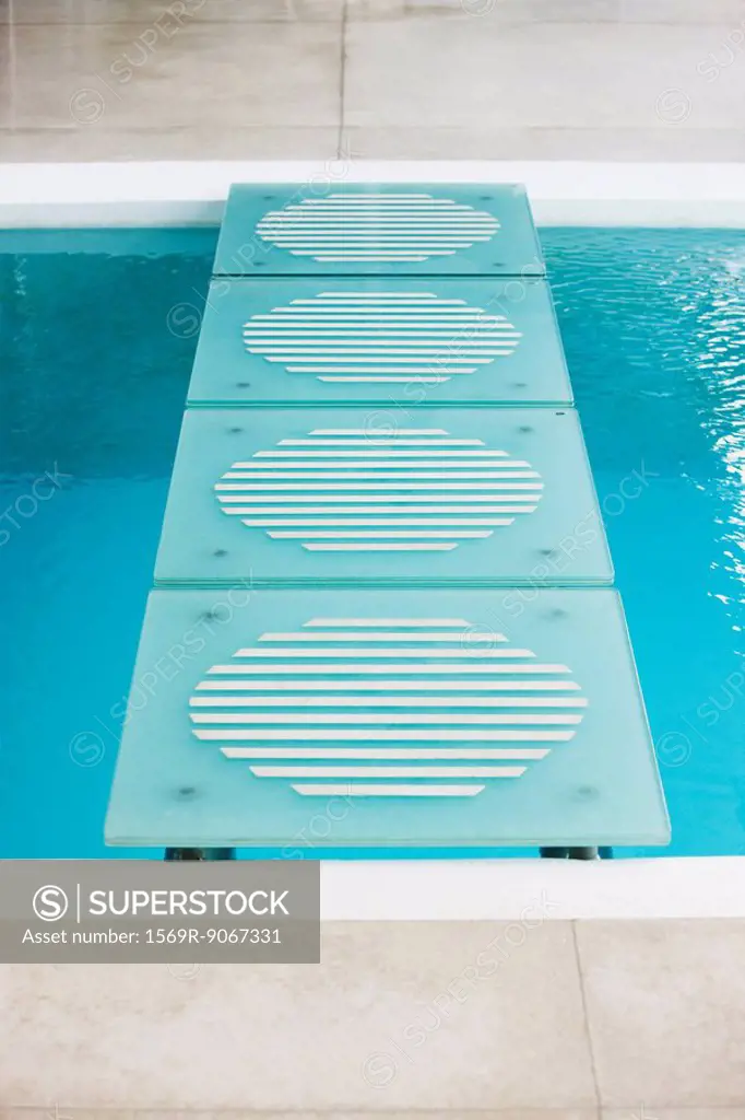 Stepping stones leading across swimming pool