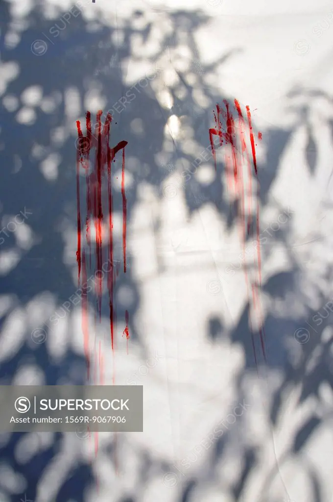 Red handprints on white sheet