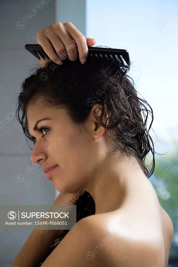Woman combing wet hair
