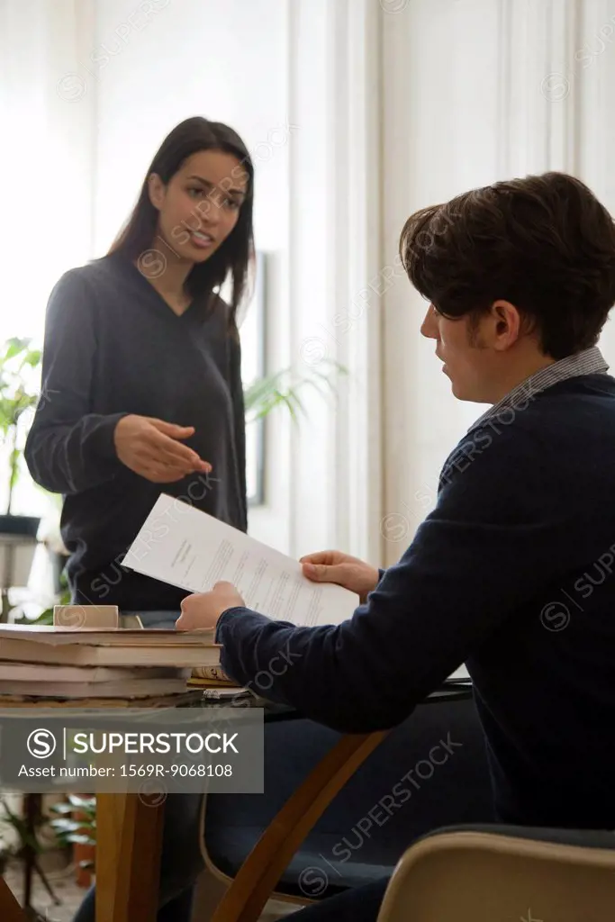 Man discussing contract with his wife