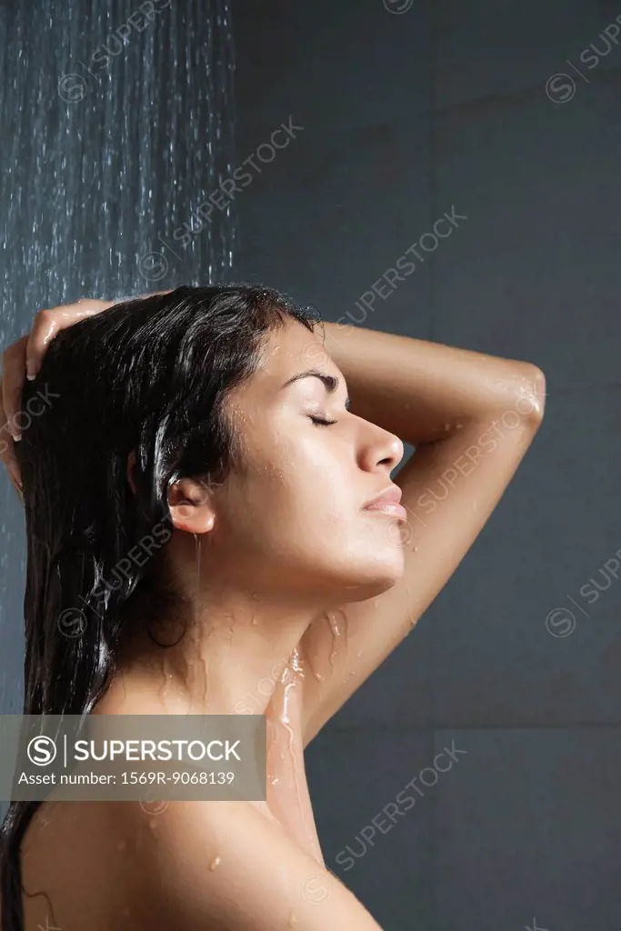 Woman in shower with eyes closed