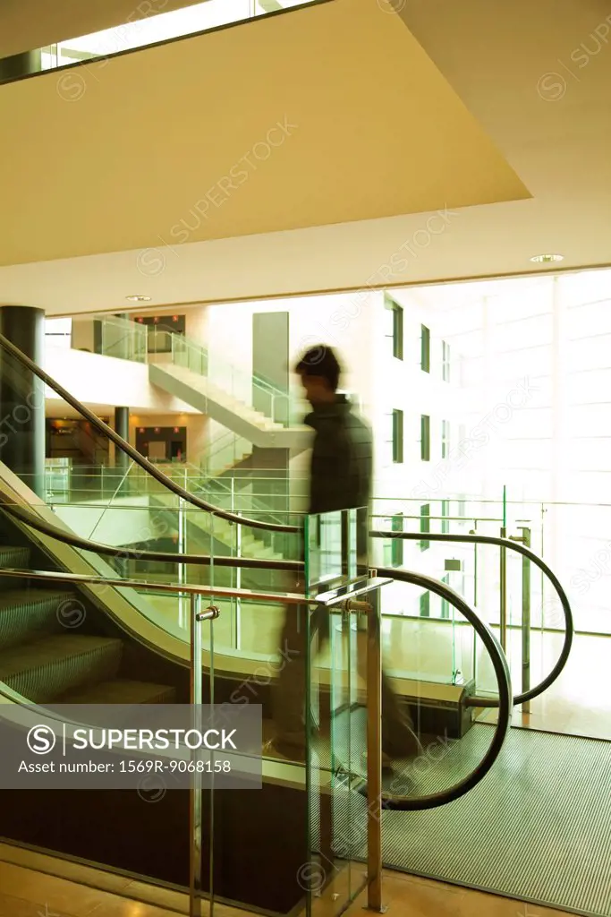 Person getting on escalator