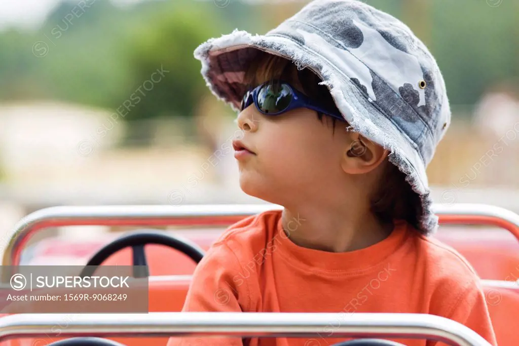 Boy on amusement park ride, portrait