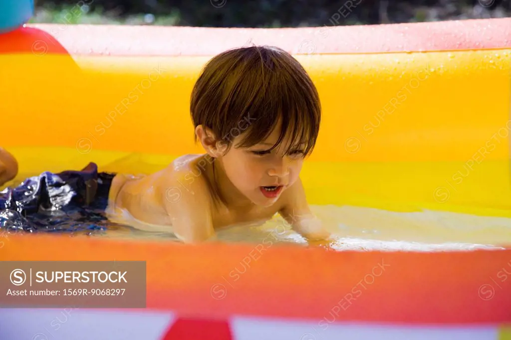 Little boy playing in wading pool