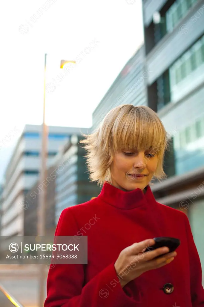 Young woman using cell phone, portrait