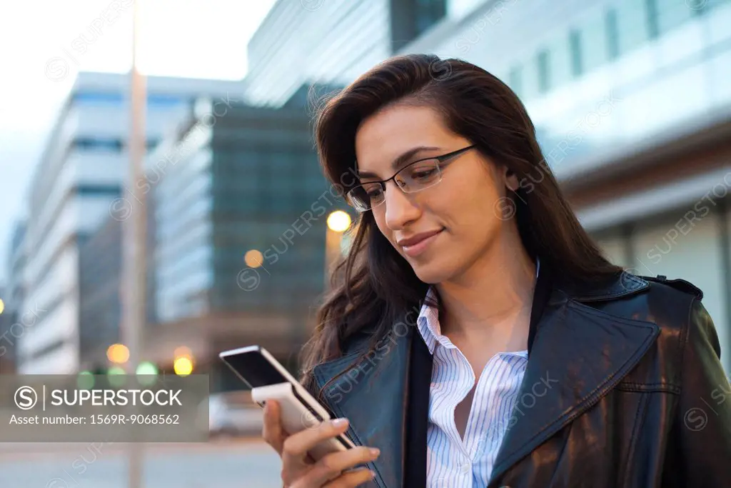Businesswoman using cell phone, portrait