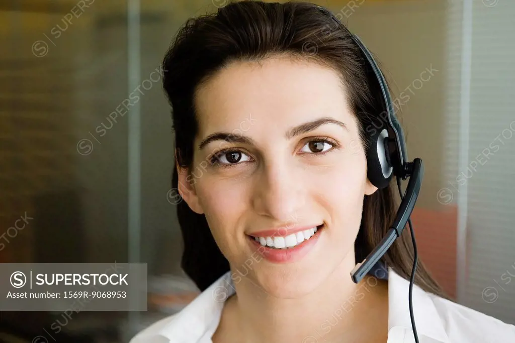 Woman wearing telephone headset, portrait