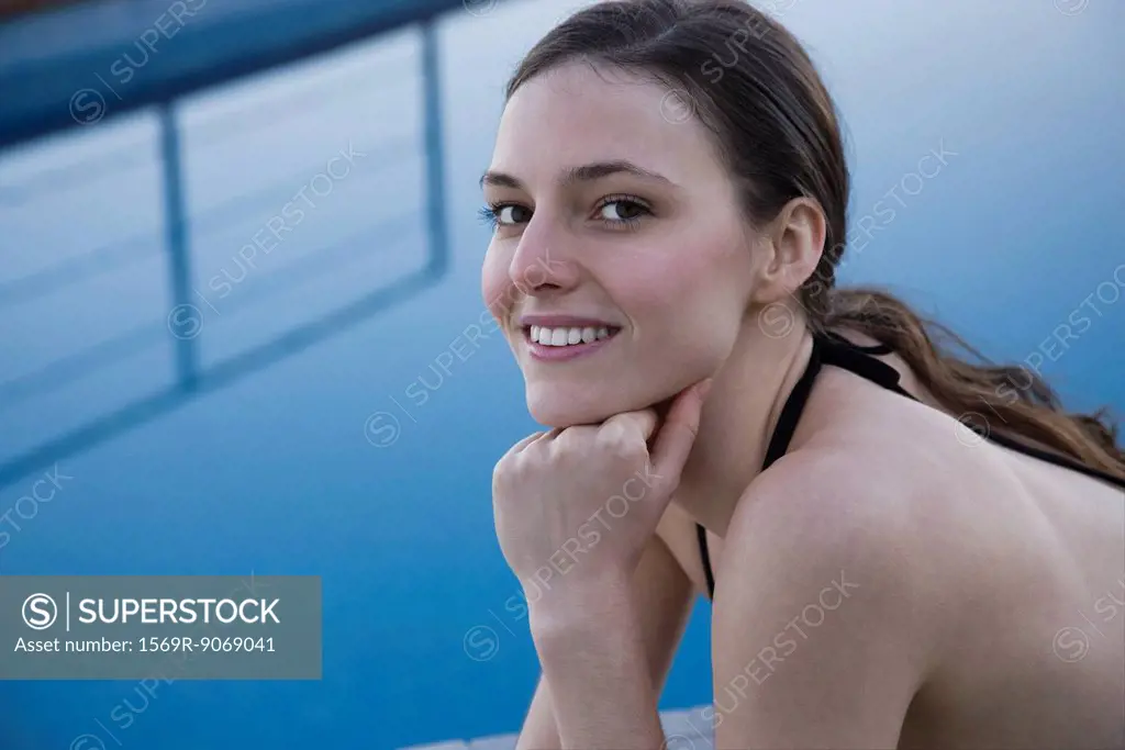 Woman beside pool, portrait