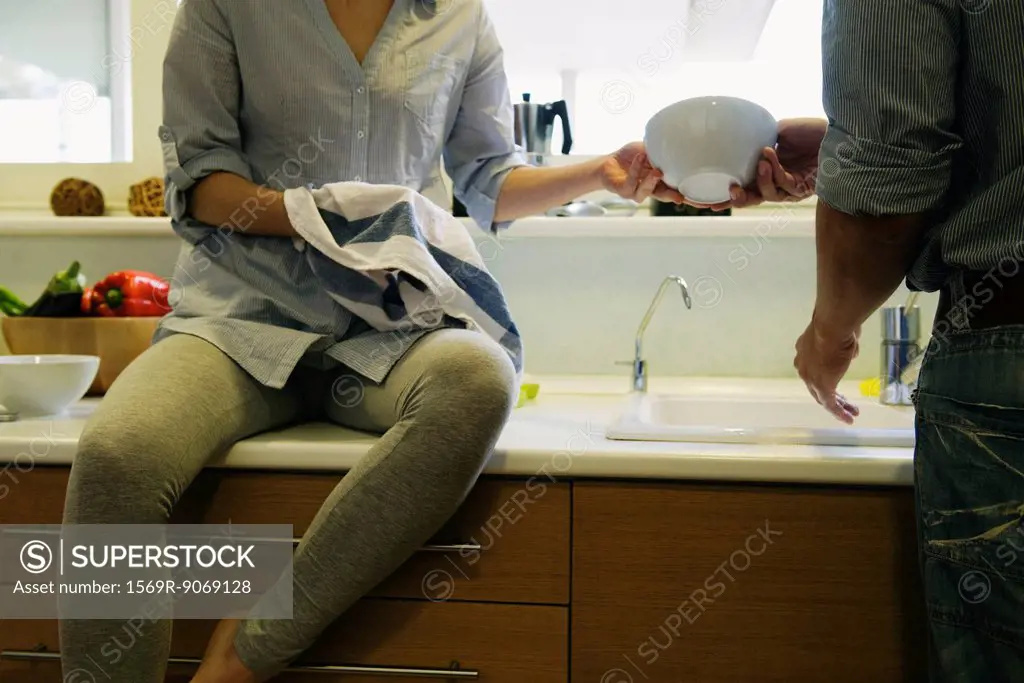 Couple washing dishes together