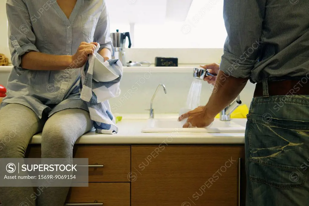 Couple washing dishes together