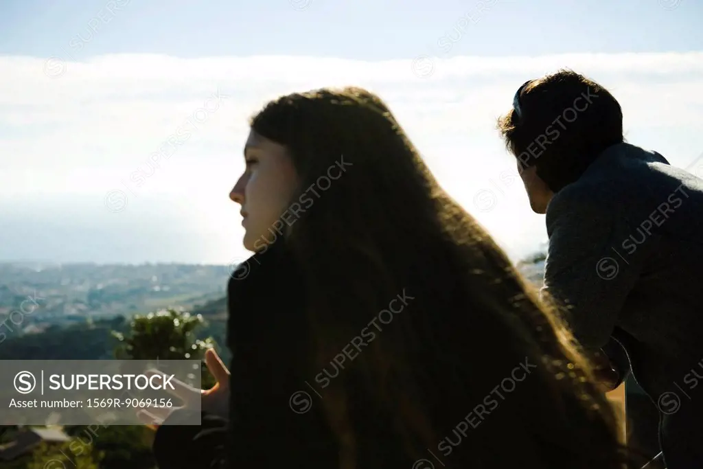 Couple on balcony, looking at view
