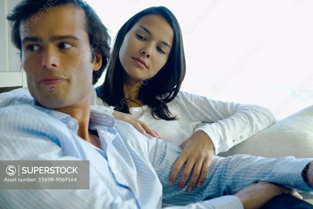 Couple relaxing together, woman caressing man´s arm