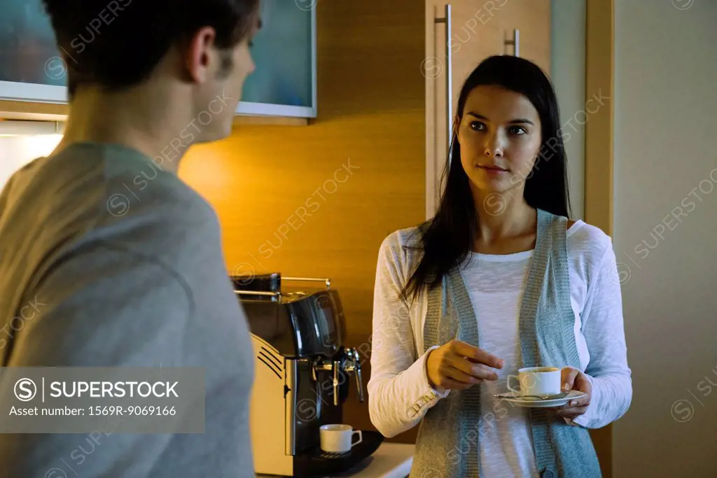 Couple enjoying coffee in kitchen