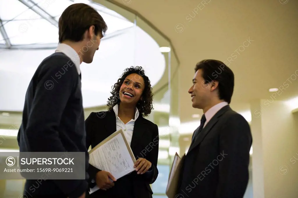 Executives chatting in corridor