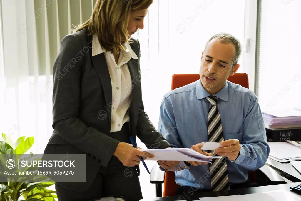 Businessman talking to colleague