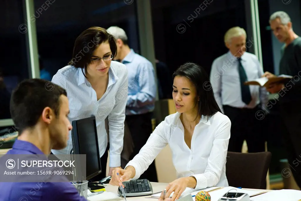 Colleagues working together in office at night