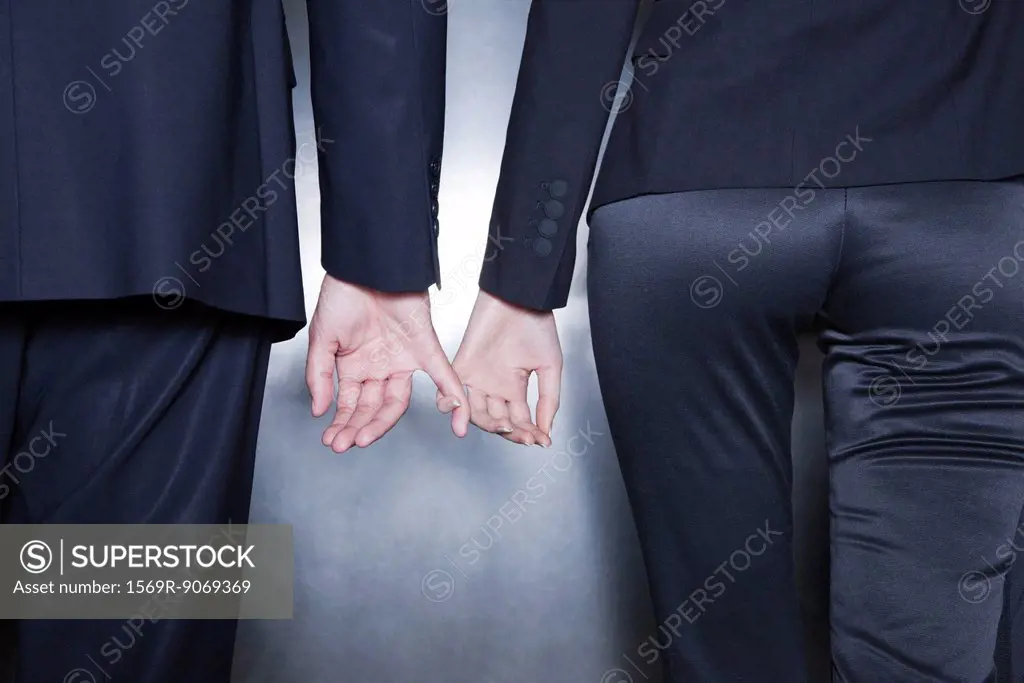 Professionals holding hands, cropped