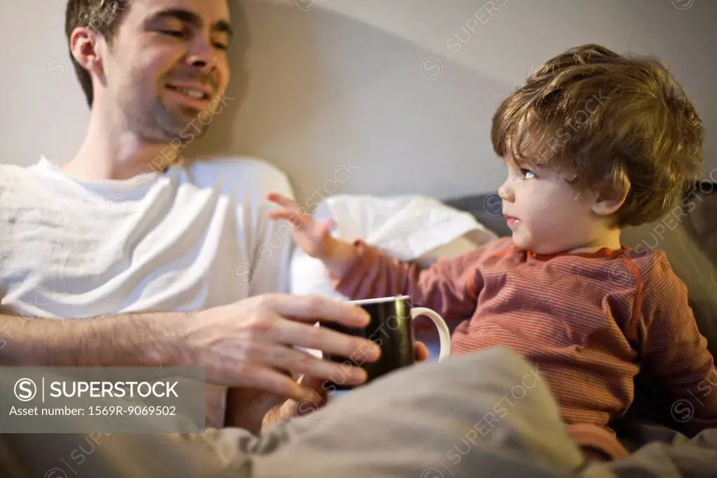 Father bonding with toddler son