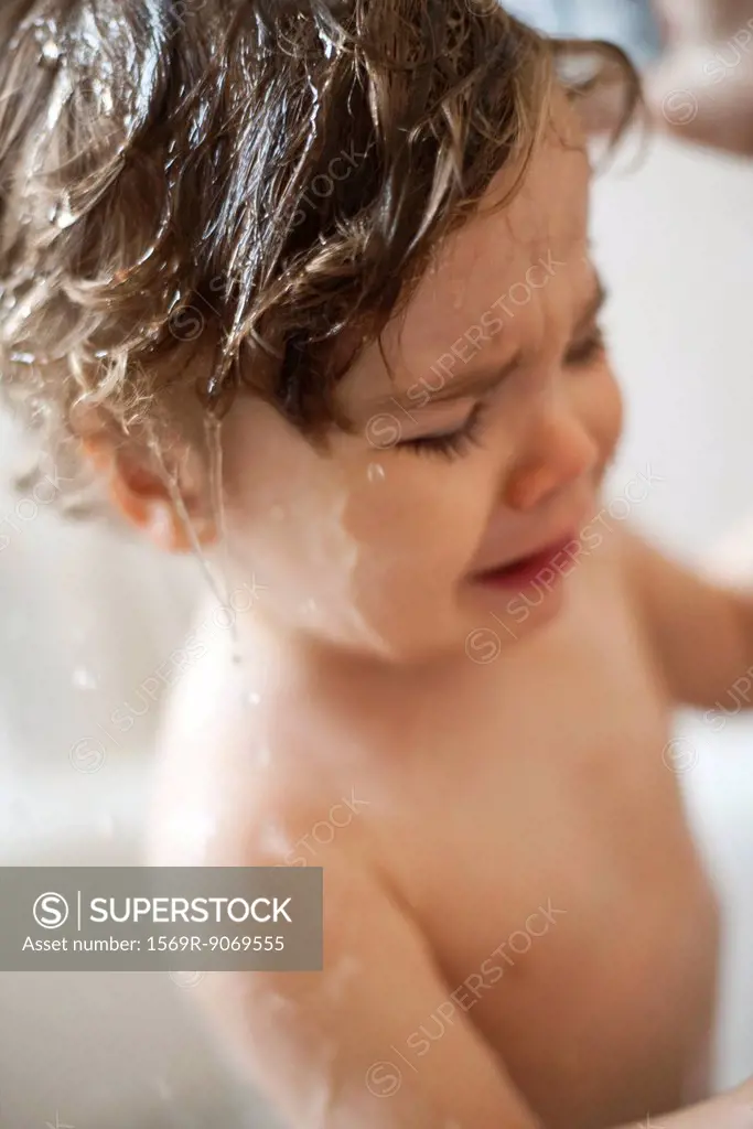 Toddler boy crying in the bath