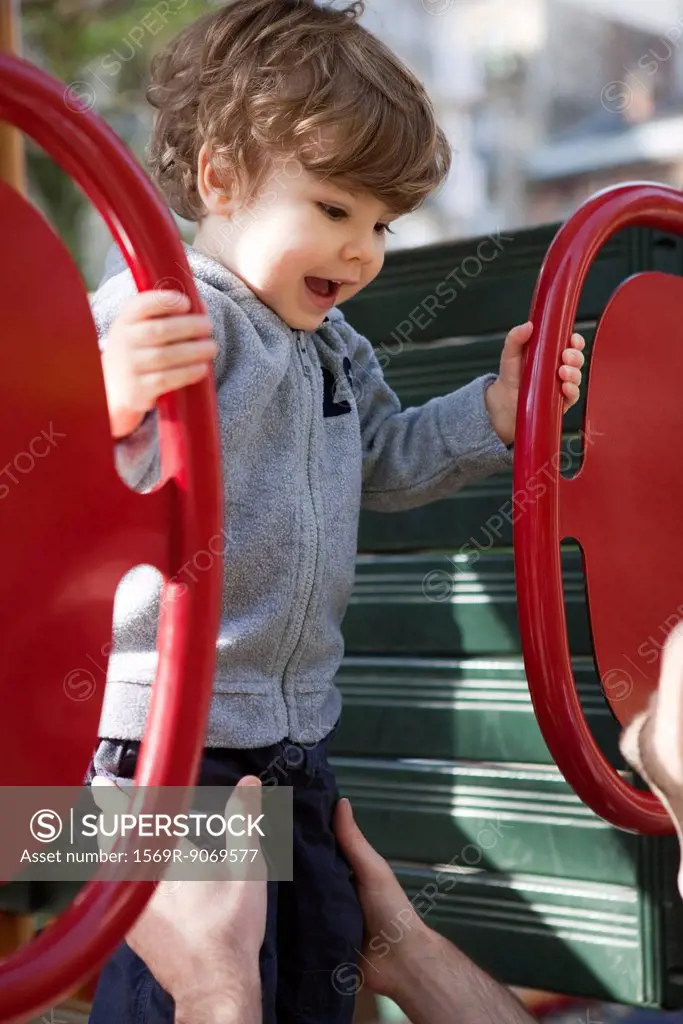 Toddler boy playing on playground