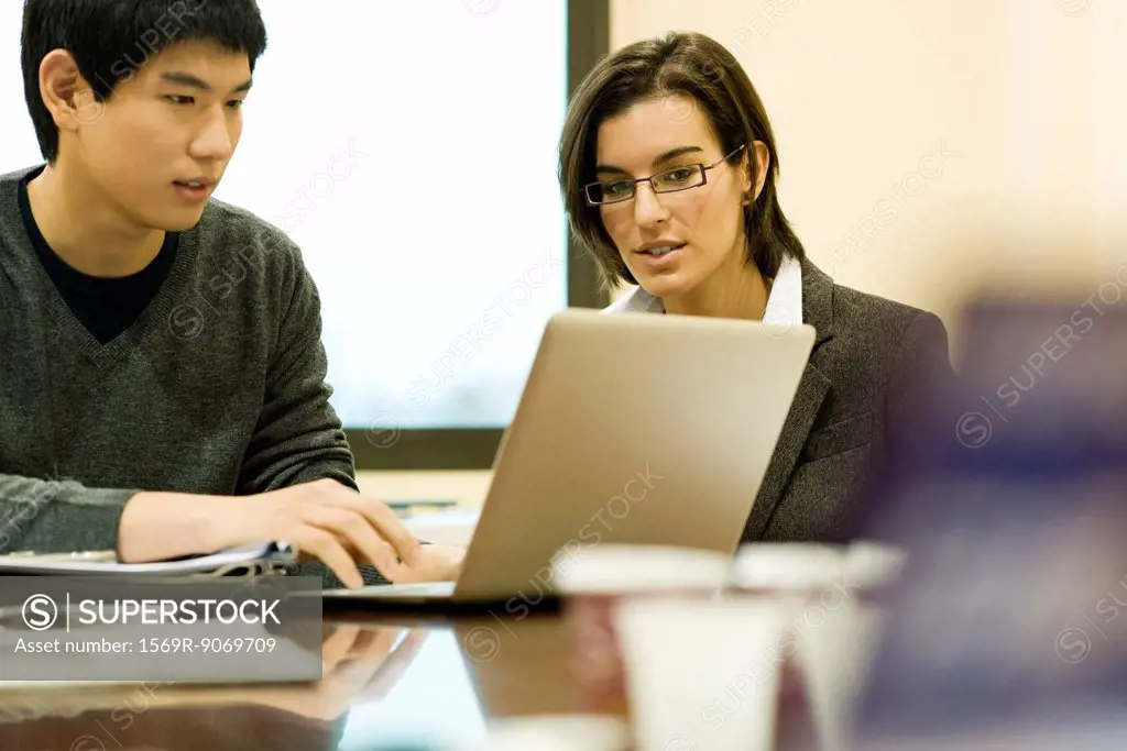 Colleagues working together on laptop computer