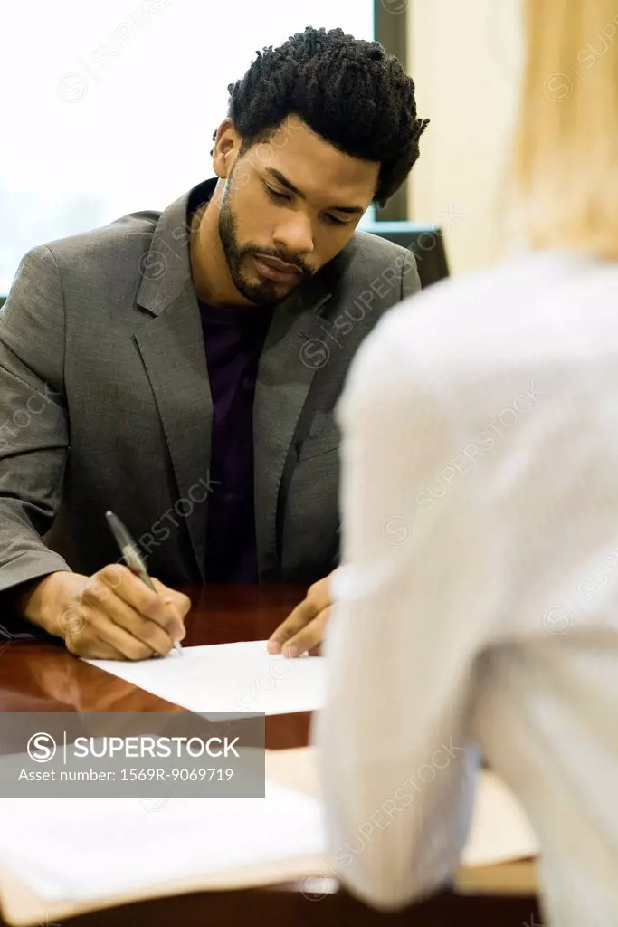 Professional man completing application at job interview