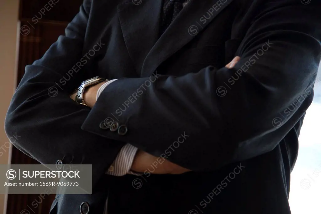 Executive with arms folded, cropped