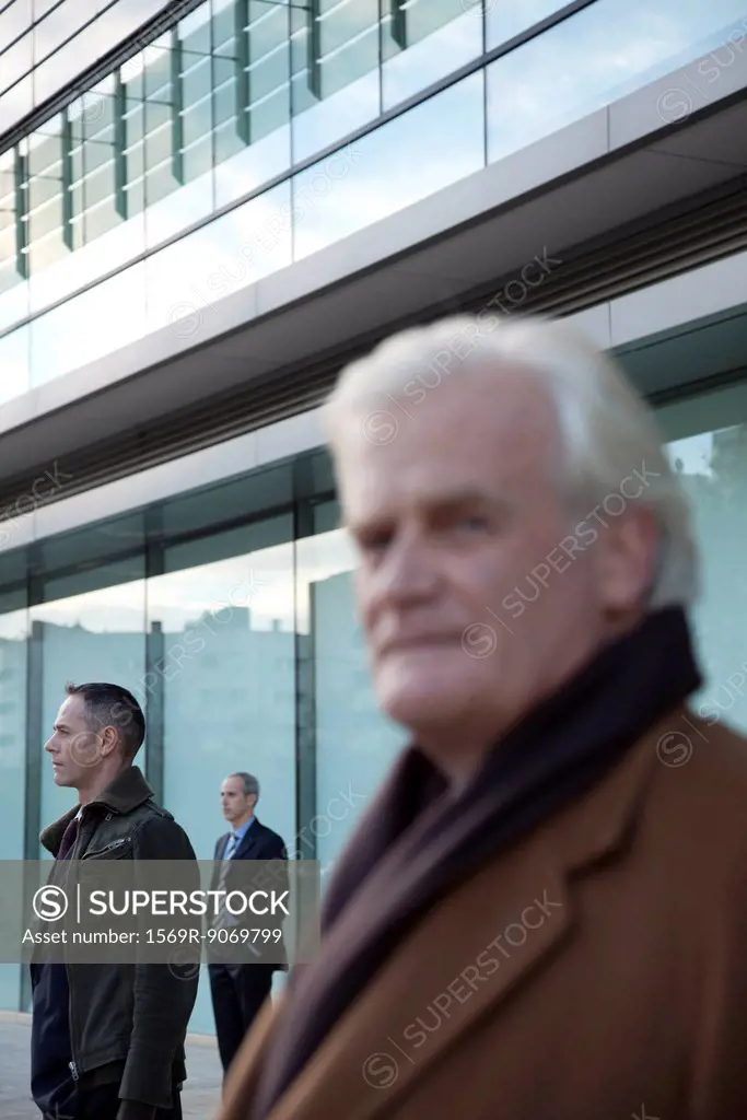 Businessmen standing in front of building