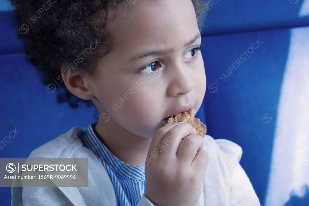 Little girl eating cookie, portrait
