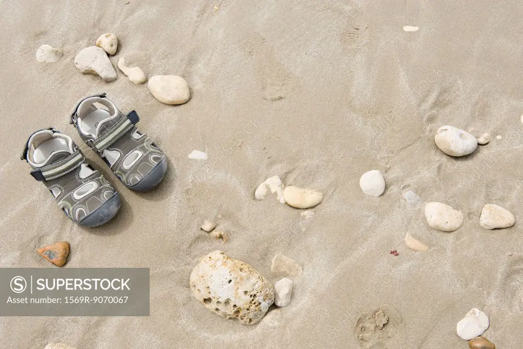 Child´s sandals on beach