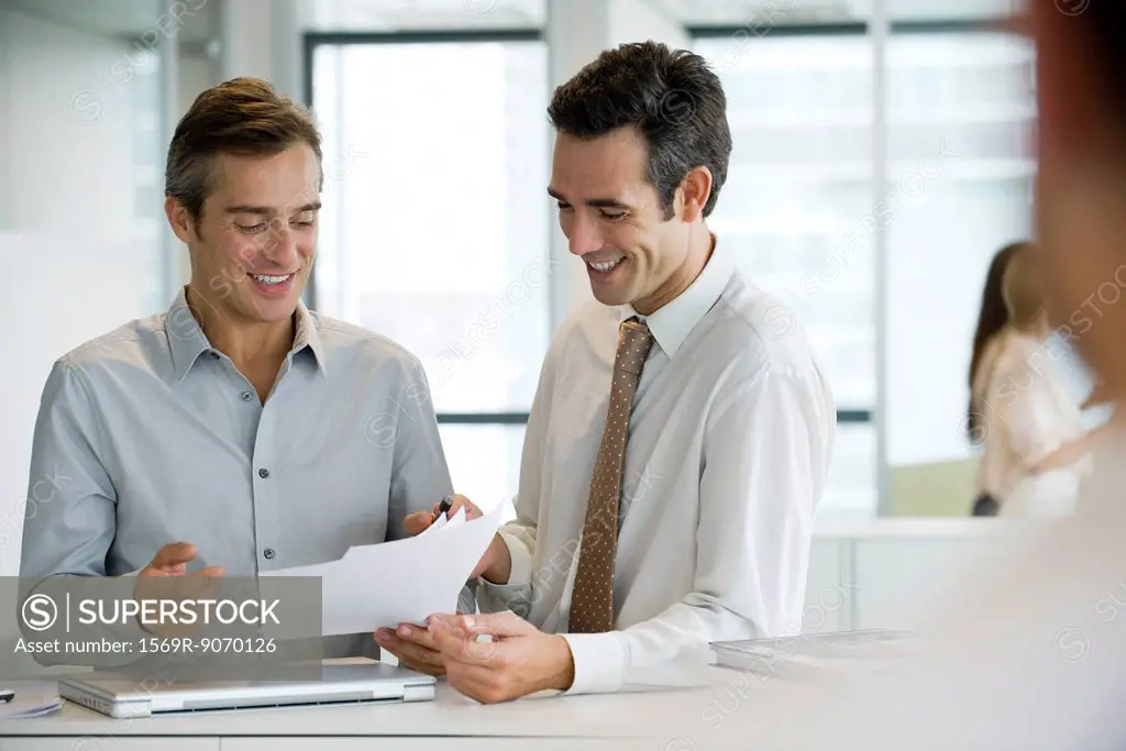 Executives discussing documents