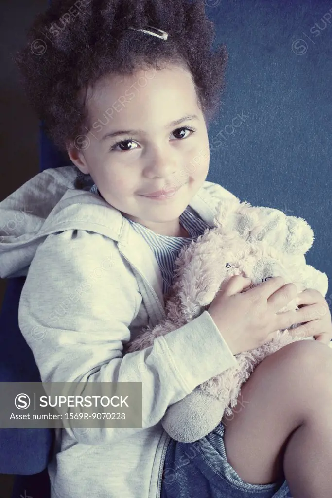 Little girl with stuffing toy, portrait